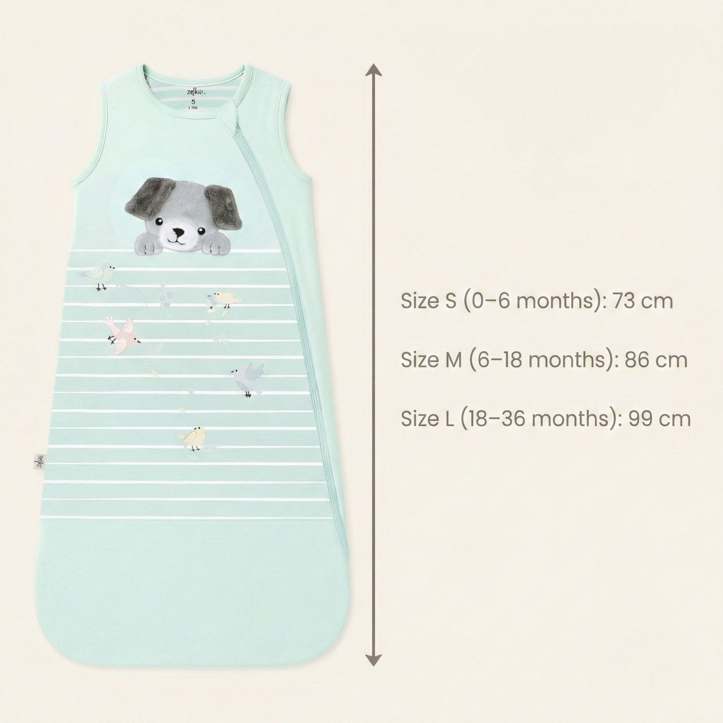 Zelkii® baby sleep sack size and fit chart showing total length measurements. Size S (0–6 months) measures 73 cm, Size M (6–18 months) measures 86 cm, and Size L (18–36 months) measures 99 cm, displayed alongside a cream sleep sack with puppy illustration.