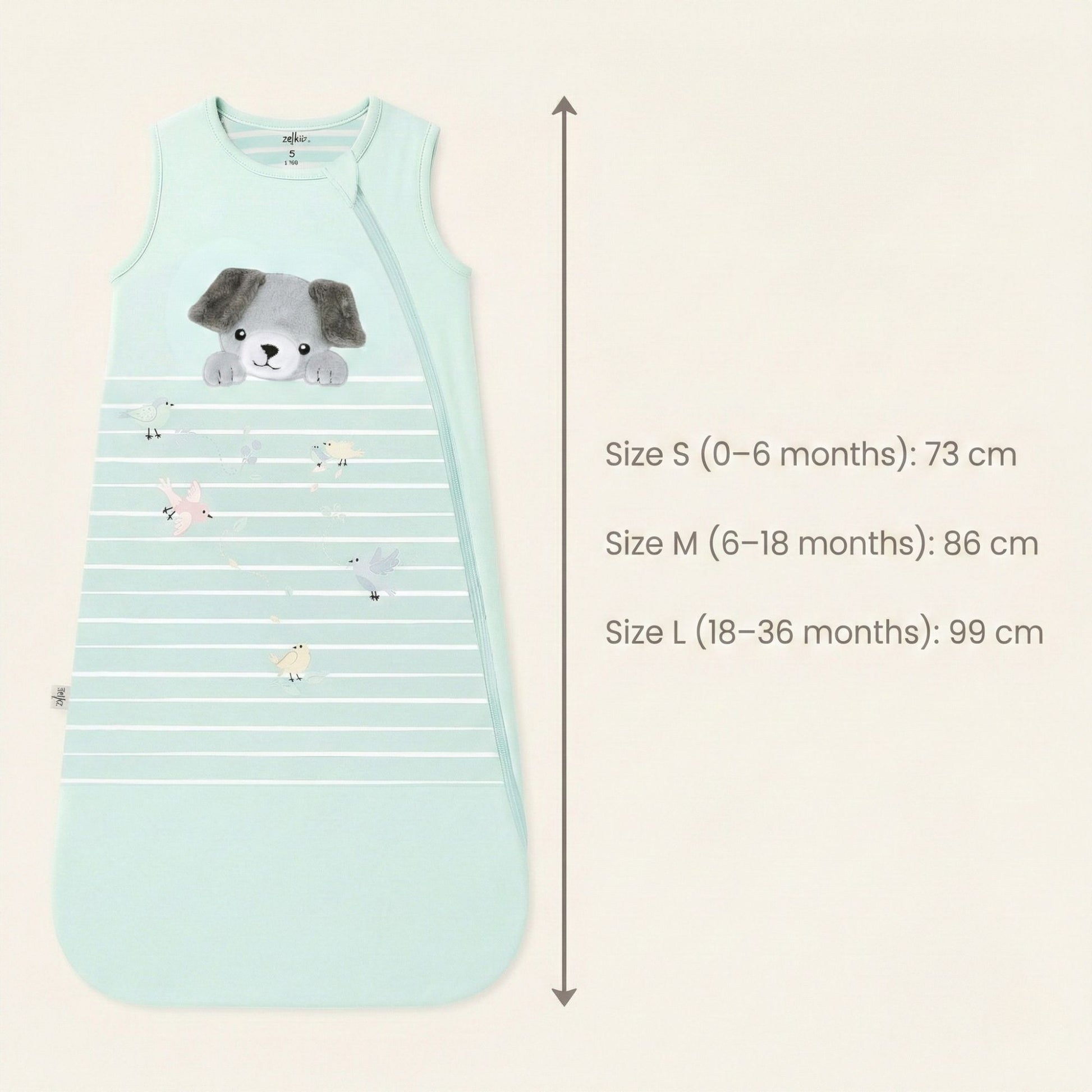 Zelkii® baby sleep sack size and fit chart showing total length measurements. Size S (0–6 months) measures 73 cm, Size M (6–18 months) measures 86 cm, and Size L (18–36 months) measures 99 cm, displayed alongside a cream sleep sack with puppy illustration.