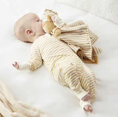 A baby in a striped teddy bear zelkii pyjamas, cuddling the 'asleep' side of a Zelkii teddy bear LuviDuvi lovey.