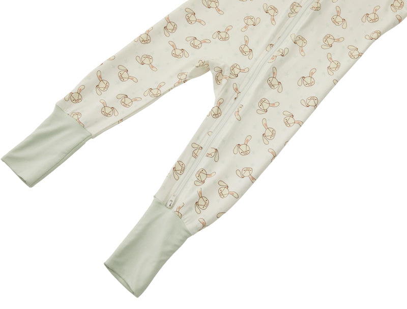 Detail shot of the Zelkii bamboo pyjamas in a yellow and cream stripe, focusing on the bunny embroidered on design.