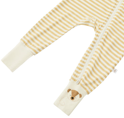 Detail shot of the Zelkii bamboo pyjamas in a yellow and cream stripe, focusing on the teddy bear embroidered on the cuff.